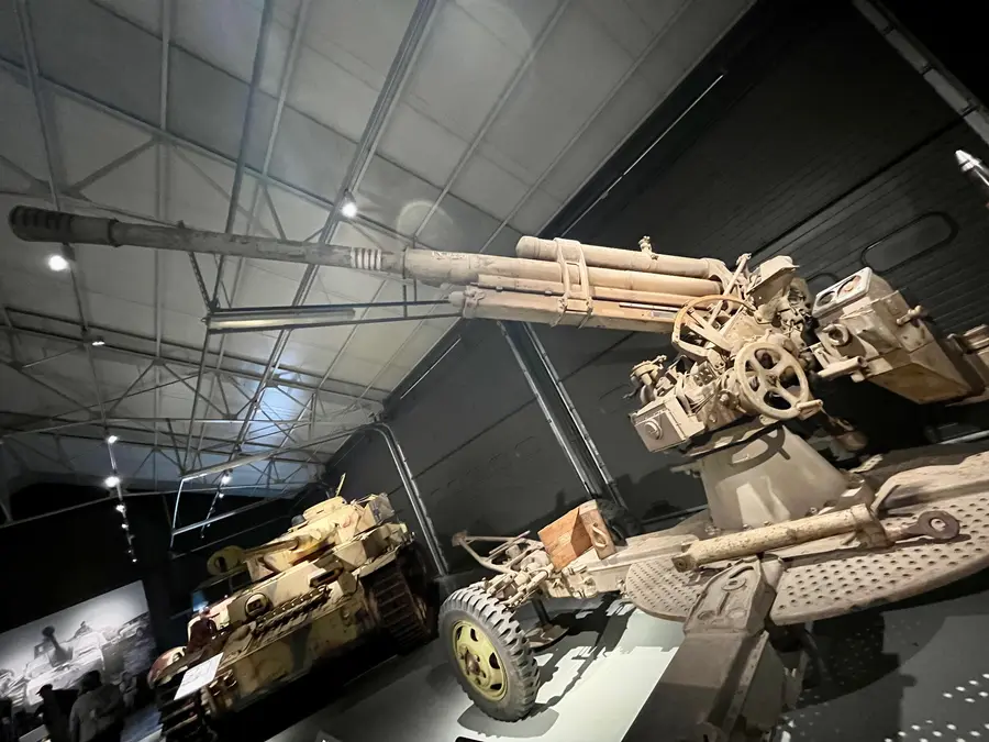 An 88mm anti-aircraft gun on its cruciform mount inside the museum.