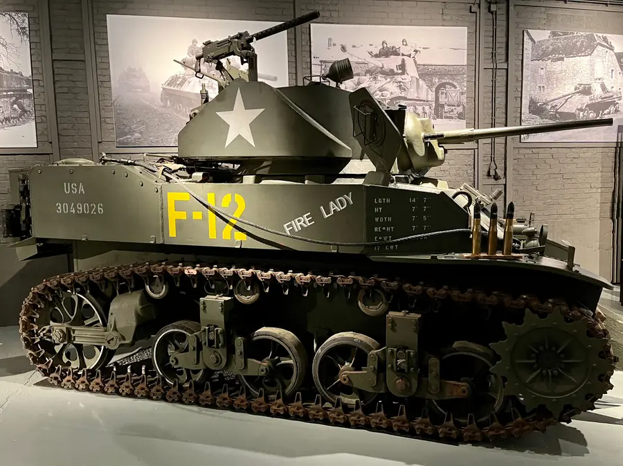 A restored M5A1 Stuart light tank in a museum hall.