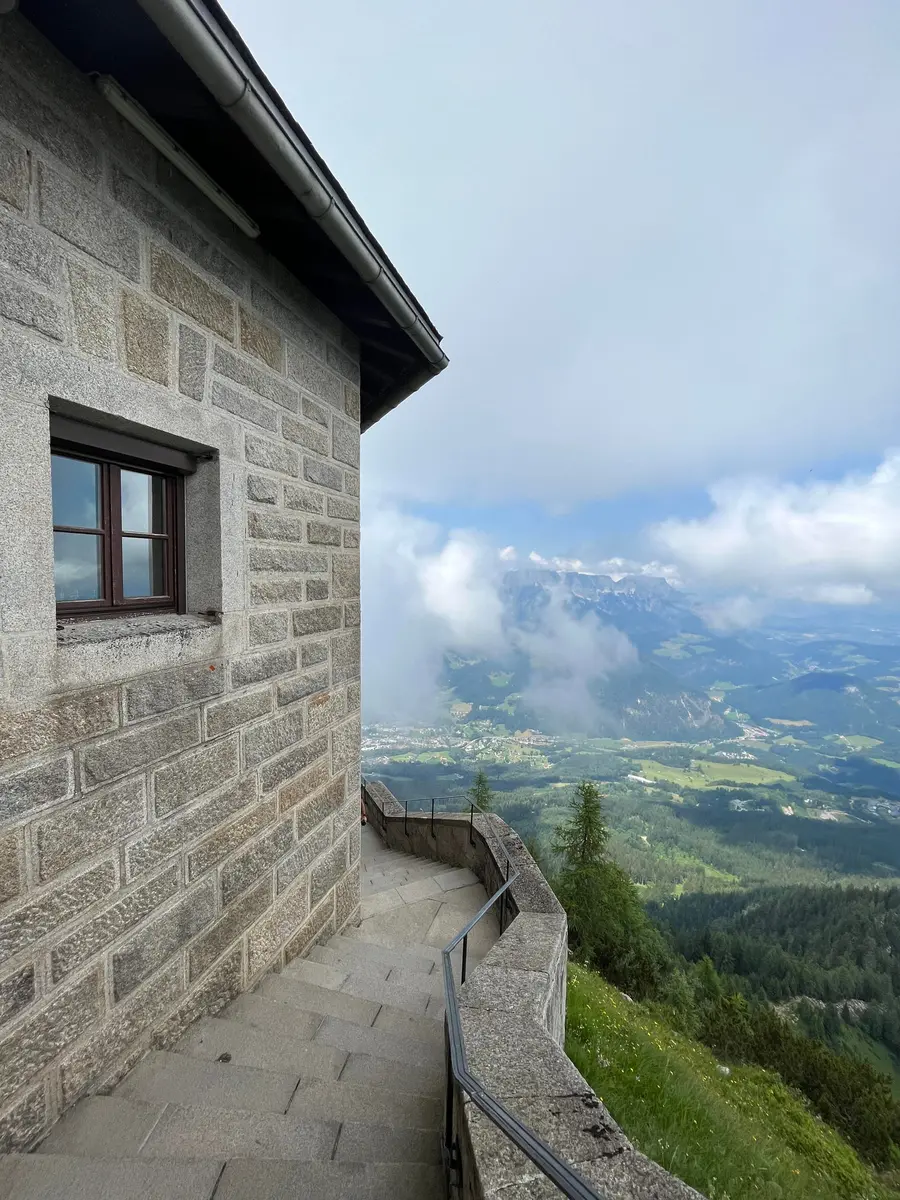 A wide view from the Eagle’s Nest across alpine ridges and valleys under a hazy sky.
